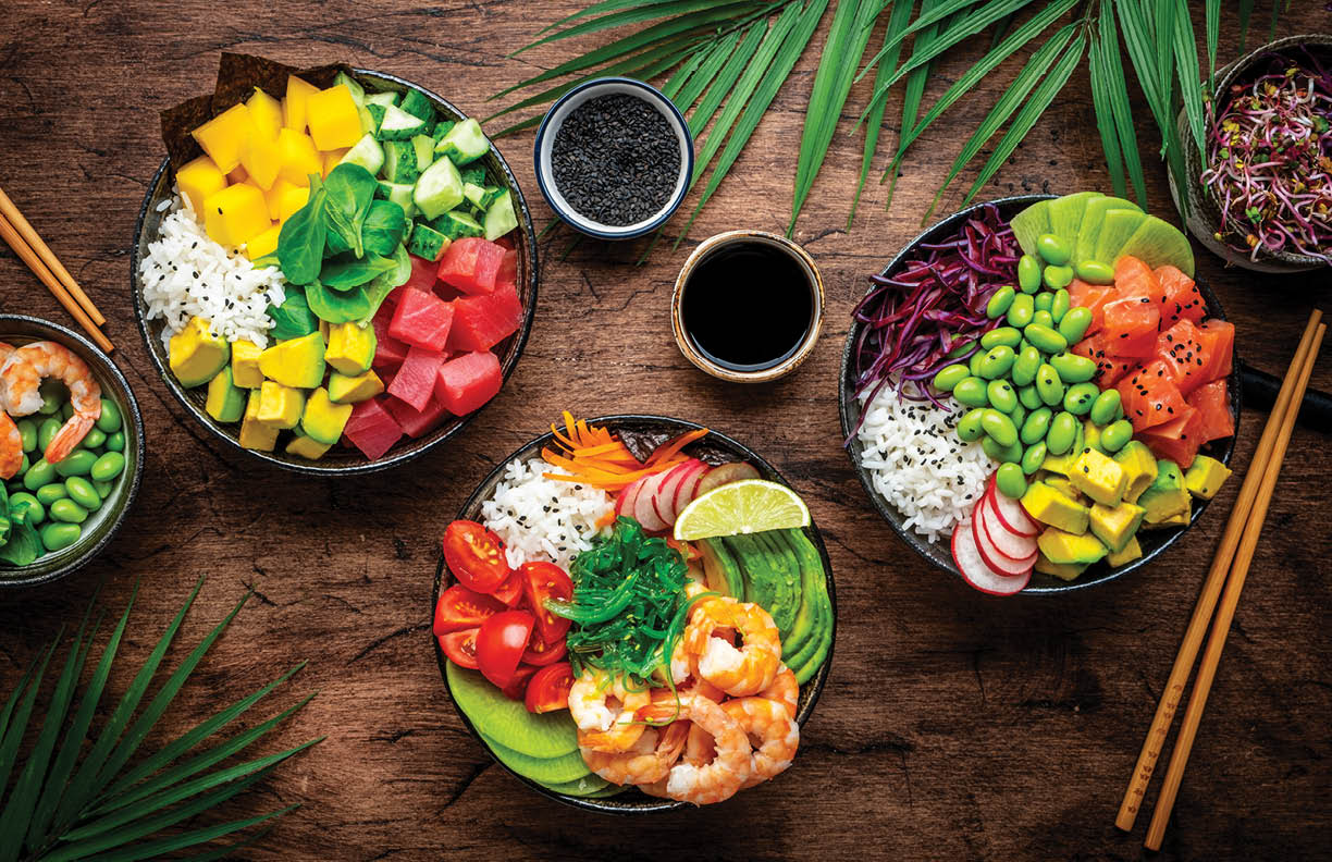 Balanced diet poke bowls with tuna, salmon, shrimp, vegetables, legumes, avocado and rice, wood table background, top view