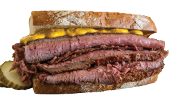 Smoked Meat Sandwich: A Montreal deli specialty, featuring tender, spiced smoked beef piled high on rye bread with mustard.