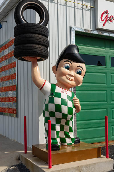 Galena, Kansas - United States - June 18th, 2025: Bob's Big Boy statue holding tires at Gearhead Curios tourist attraction on historical Route 66 in Galena, Kansas, USA.