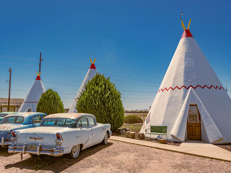 Holbrook, AZ, US-April 13, 2024: Wigwam Motel, part of a motel chain built during the 1930s and 1940s on historic Route 66. The rooms are in teepees with classic cars in front.