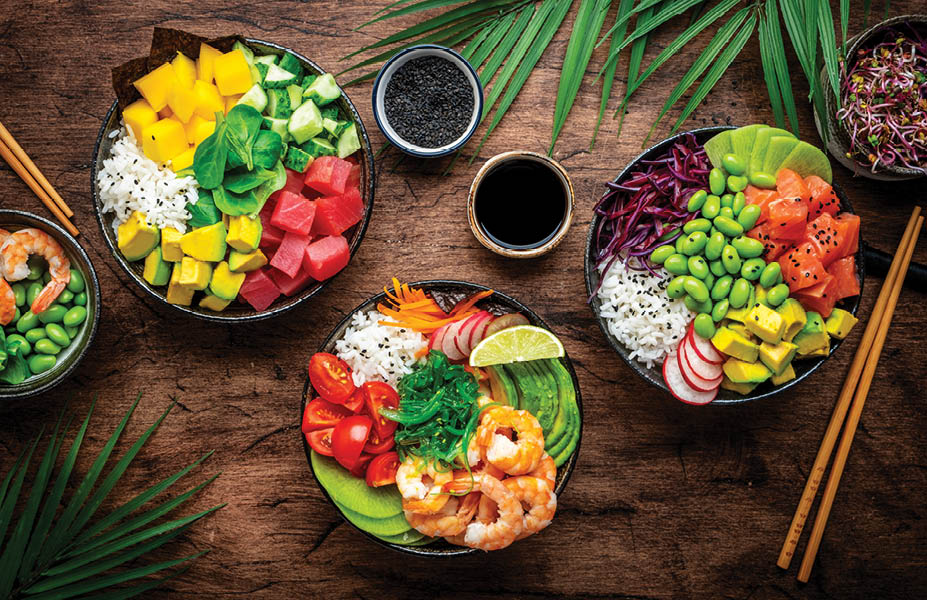 Balanced diet poke bowls with tuna, salmon, shrimp, vegetables, legumes, avocado and rice, wood table background, top view