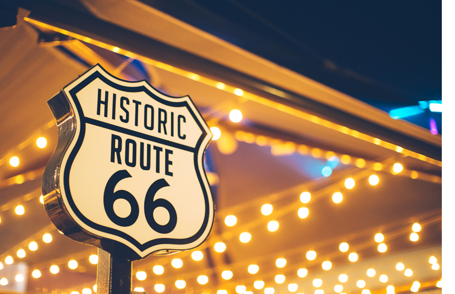 Historic Route 66 sign in California with decoration lights on the background