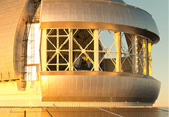 Close up of Gemini observatory with open wind vents on Maunakea volcano on the Big Island of Hawaii. Photo lightly desaturated to remove some of the intense reflected color cast from the sunset.