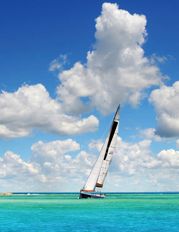 Sailboat sailing on the clear waters of tropical paradise in Saint Maarten