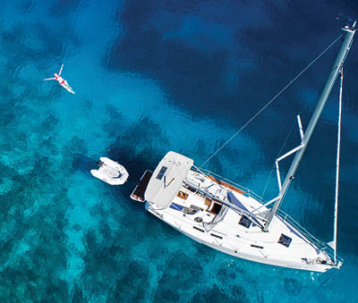 amazing view to yacht, swimming woman and clear water - caribbean paradise