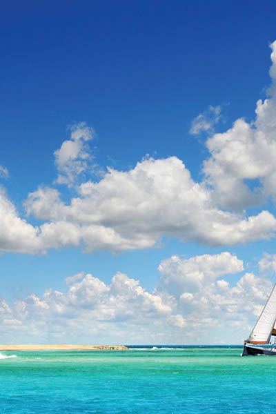 Sailboat sailing on the clear waters of tropical paradise in Saint Maarten