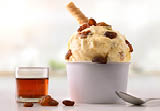 Raisins ice cream cup on white table homemade with kitchen background. Horizontal composition. Front view.