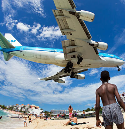 Aircraft KLM Asia / Boeing 747-406M / PH-BFY / FY-041 (cn 30455/1302) in flight. Plane is landing in Philipsburg / St. Maarten - Princess Juliana Airport near the beach