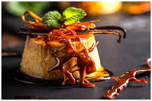 Vanilla flan dessert served on black slate