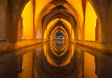 baths of the royal alcazar seville indirect lighting reflecting in the water