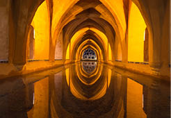 baths of the royal alcazar seville indirect lighting reflecting in the water
