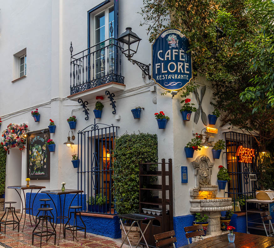 Marbella, Spain; February 29 2024: The photograph captures a charming street in Marbella, where the white walls of the buildings contrast with the vibrant colors of the flowers