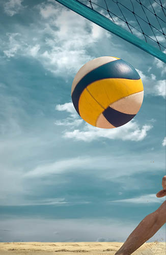 Beach volleyball player in action at sunny day under blue sky.