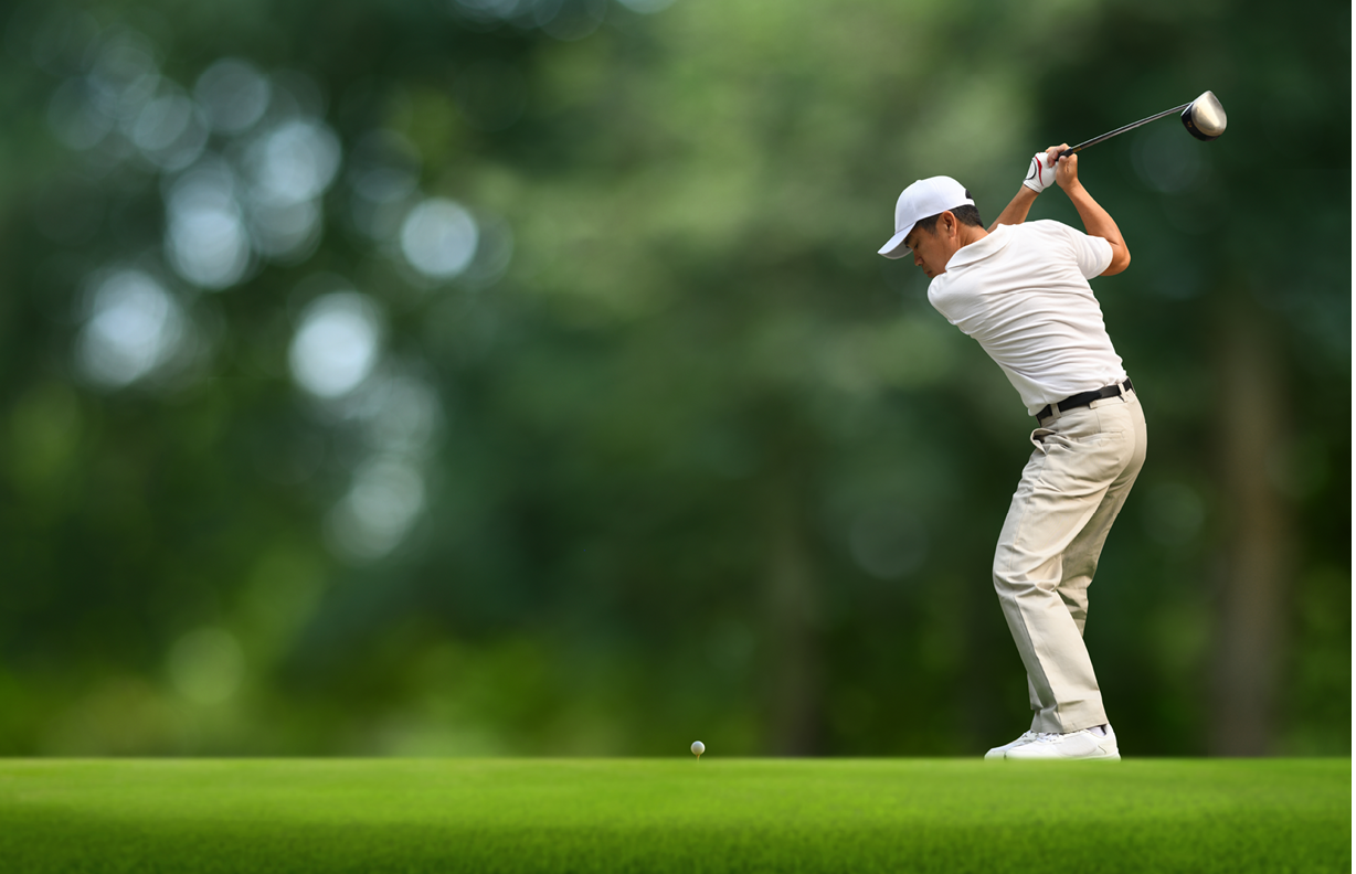 Front view of Golfer driver back swing before hitting golf ball down the fairway.