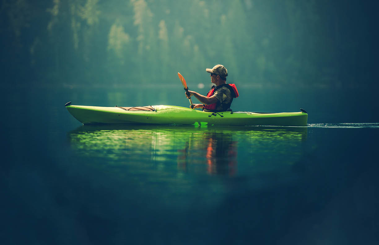 Kayak Tour on the Lake. Middle Age Caucasian Men in the Kayak on the Scenic Lake.