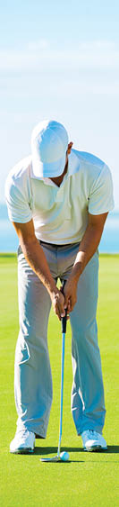 Golfer on Putting Green Hitting Golf Ball into the Hole