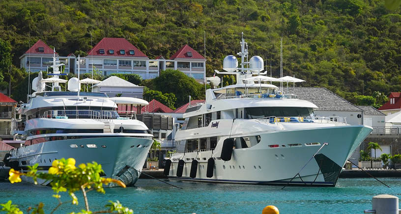 ST BARTS, FRENCH WEST INDIES - FEBRUARY 5, 2021: Mega yachts anchored in Gustavia harbor. It is the capital of Saint Barthelemy, a French-speaking Caribbean island commonly known as St. Barts