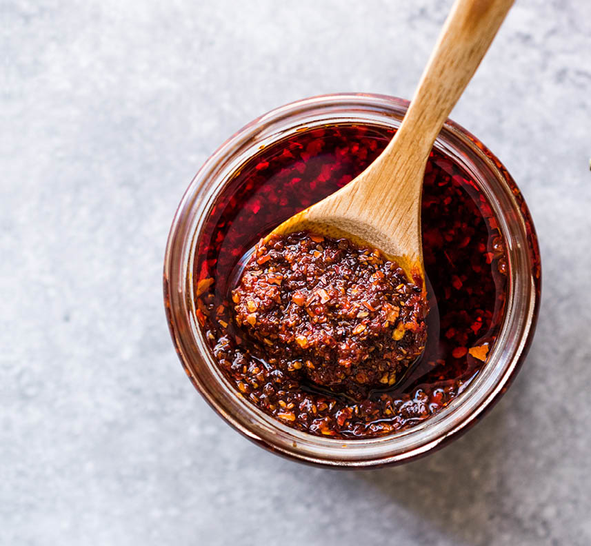 Hot Mexican Spicy Chili Red Sauce Salsa Macha with Red Pepper Powder in Jar.