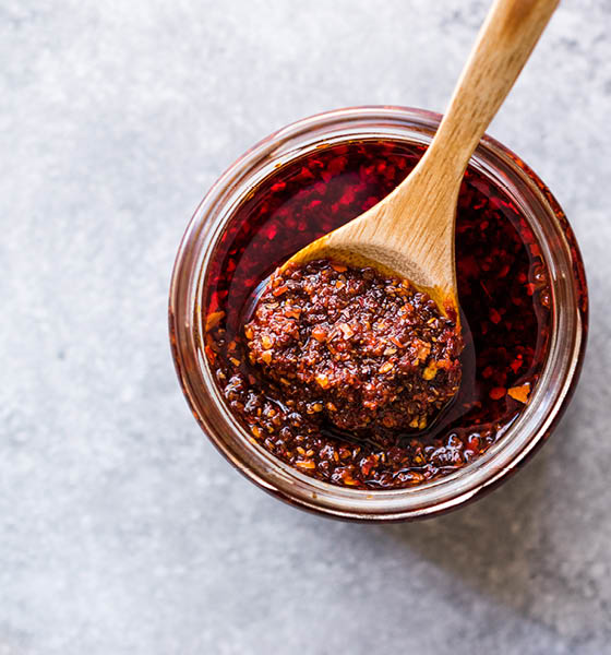 Hot Mexican Spicy Chili Red Sauce Salsa Macha with Red Pepper Powder in Jar.