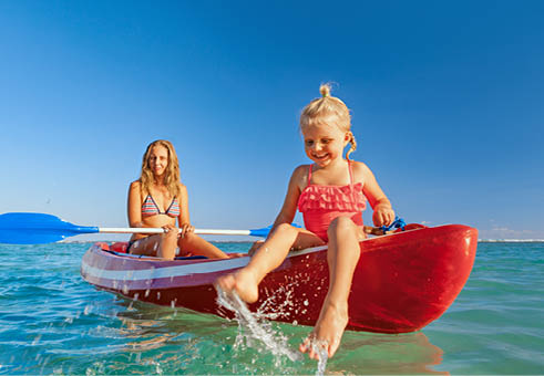 Happy family - young mother, children have fun on boat walk. Woman and child paddling on kayak. Travel lifestyle, parents with kids recreational activity, watersports on summer sea beach vacation.
