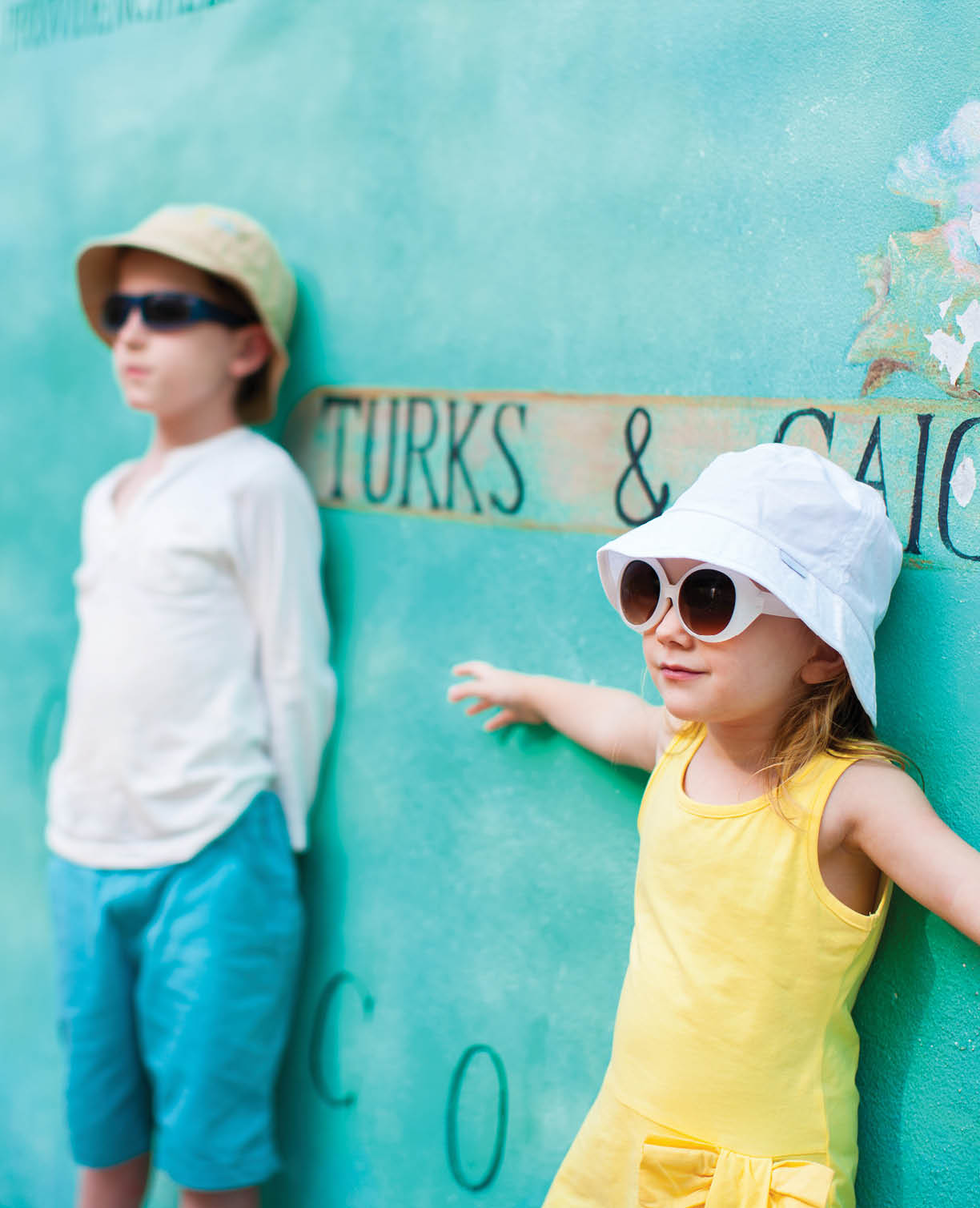 Adorable kids outdoors against colorful wall on summer day