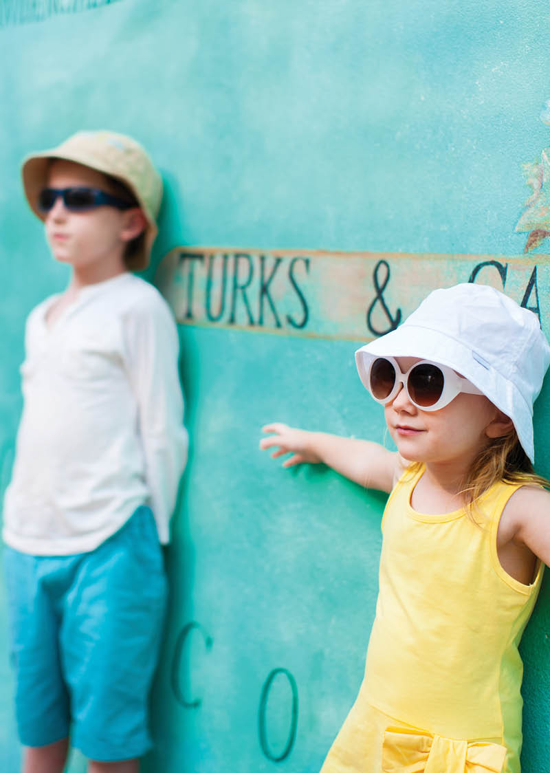 Adorable kids outdoors against colorful wall on summer day