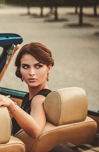 Wealthy couple in a classic convertible 