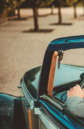 Wealthy couple in a classic convertible 