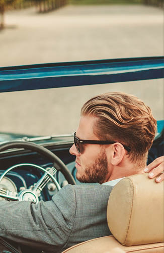 Wealthy couple in a classic convertible 