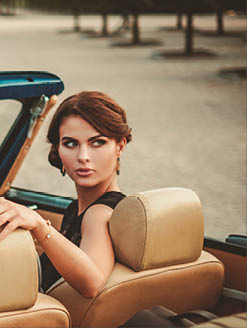 Wealthy couple in a classic convertible 