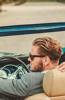 Wealthy couple in a classic convertible 