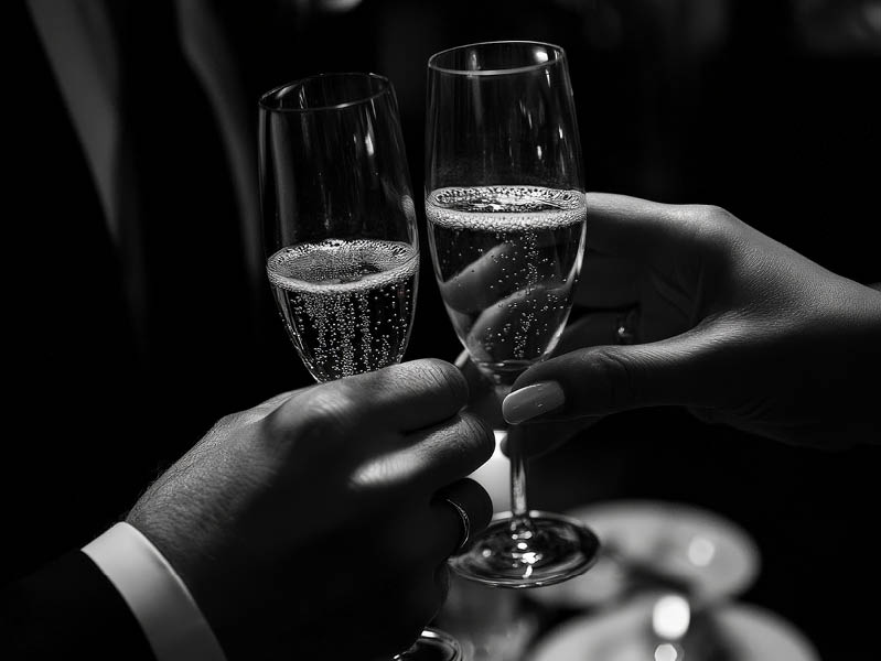 Photography of a bride and groom €™s hands toasting with champagne, with their rings subtly visible. --ar 3:2 --style raw --v 6.1 Job ID: b2d4a0c6-2a54-480d-a6f7-d4bd7cf27a85