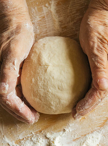 Cooking at home, old woman's hands hands kneading dough