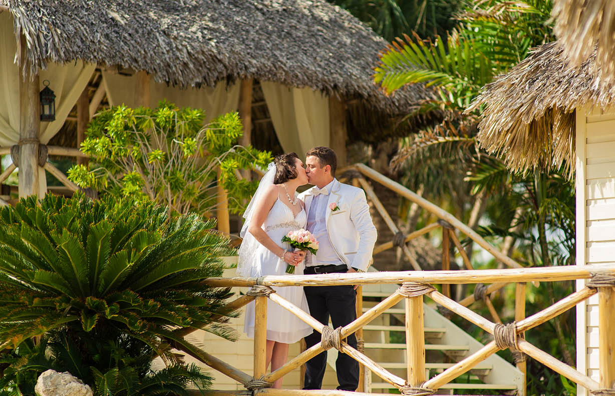 beautiful couple on the beach in wedding dress. young loving couple on tropical sea background - wedding on beach