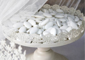 closeup of a wedding party, a vintage metal tray with colorful confetti in it 