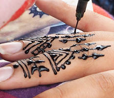 Henna tattoos being put on girls hand in Morocco