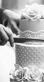 A bride and a groom is cutting their wedding cake. beautiful cake. nicel light. wedding concept