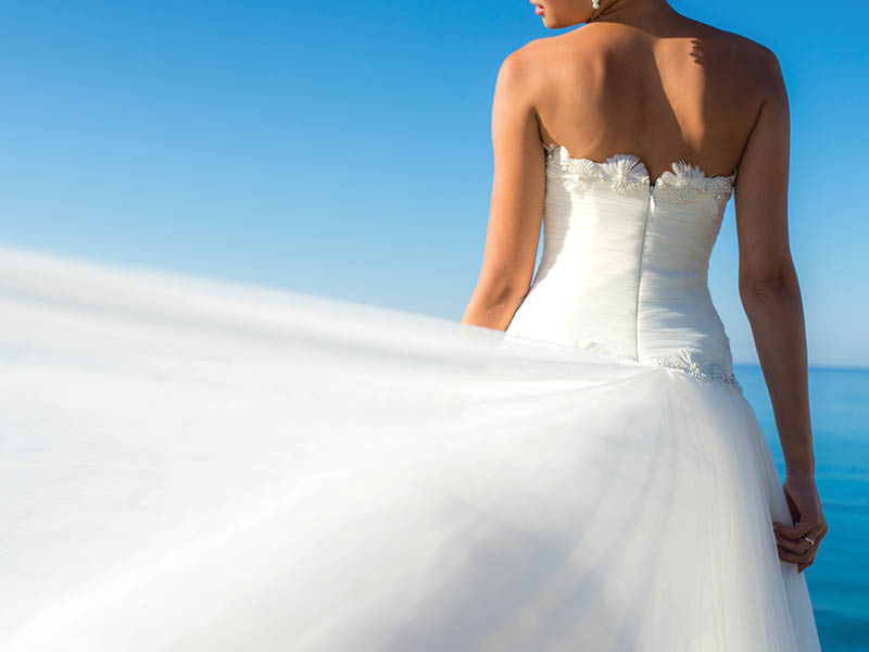 Close up bride dress against the sea