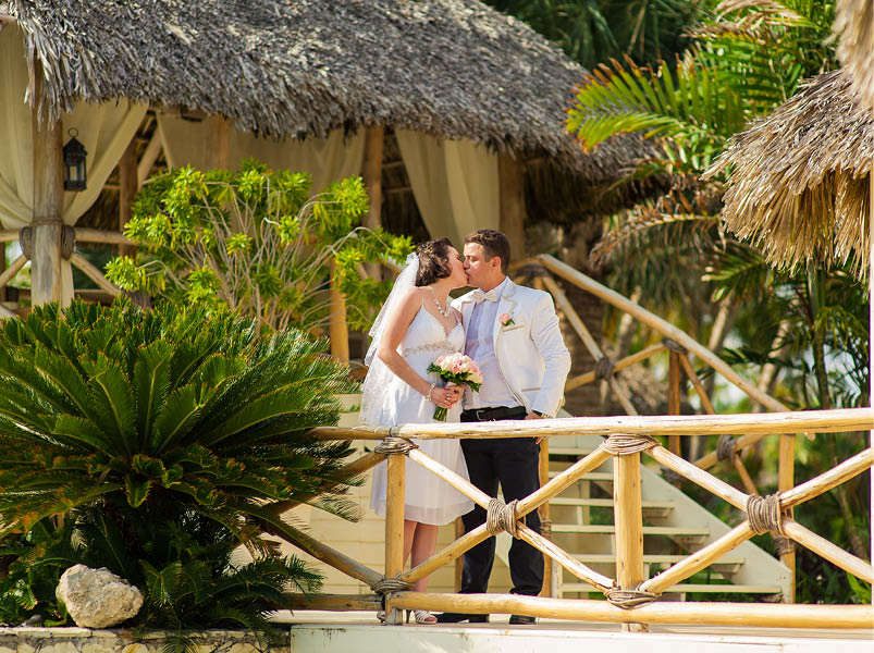 beautiful couple on the beach in wedding dress. young loving couple on tropical sea background - wedding on beach