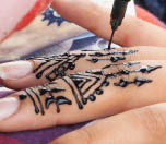 Henna tattoos being put on girls hand in Morocco