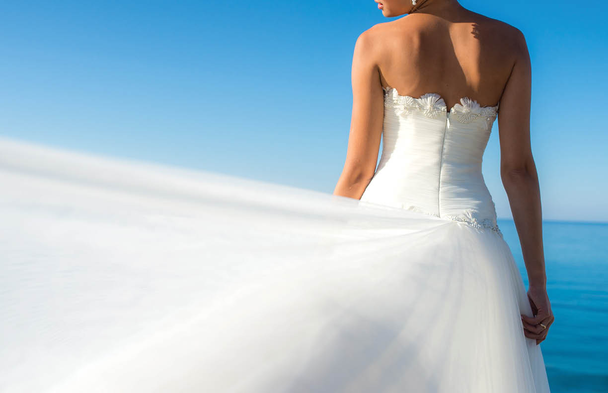 Close up bride dress against the sea
